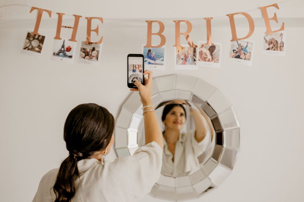 A bride's friend taking a picture of the gallery dedicated to Marie | Esthesis Events
