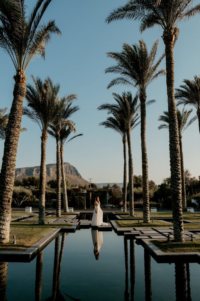 Marie posing under the palm trees at Kipos Aisthiseon | Esthesis Events