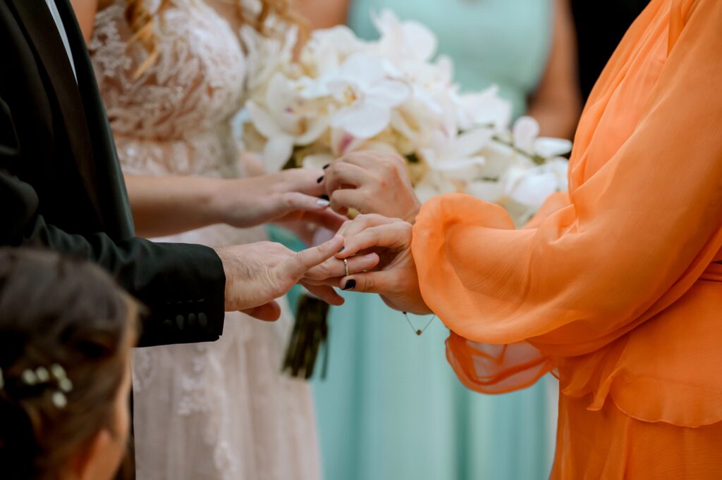 Marie and Theodore receiving their wedding rings by the best woman during the ceremony | Esthesis Events