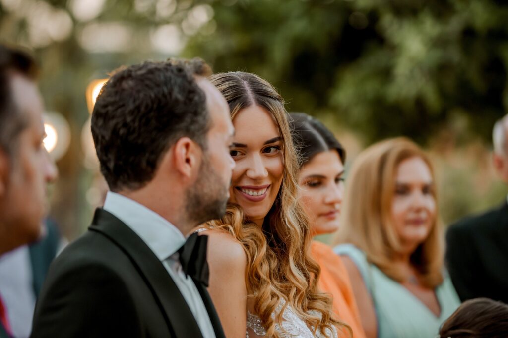 Marie and Theodore looking at each other smiling during the wedding ceremony | Esthesis Events
