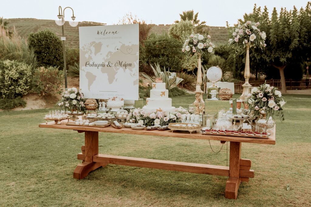 The welcome sign and the dessert station before the wedding feast | Esthesis Events