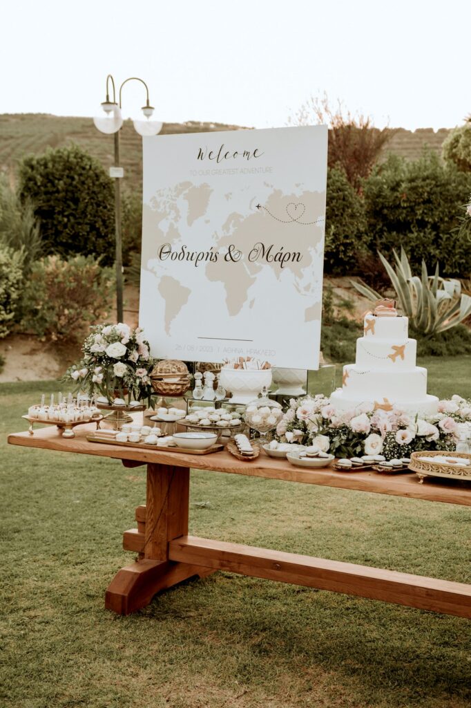 The welcome sign and the dessert station before the wedding feast | Esthesis Events