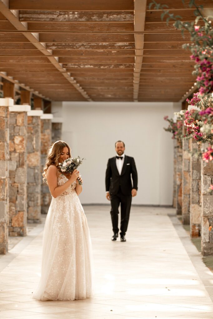 Marie holds the bridal bouquet as Theodore approaches her | Esthesis Events