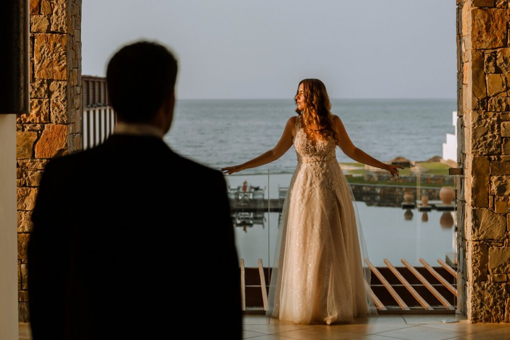 Marie posing with the sea in the backround as Theodore is watching | Esthesis Events