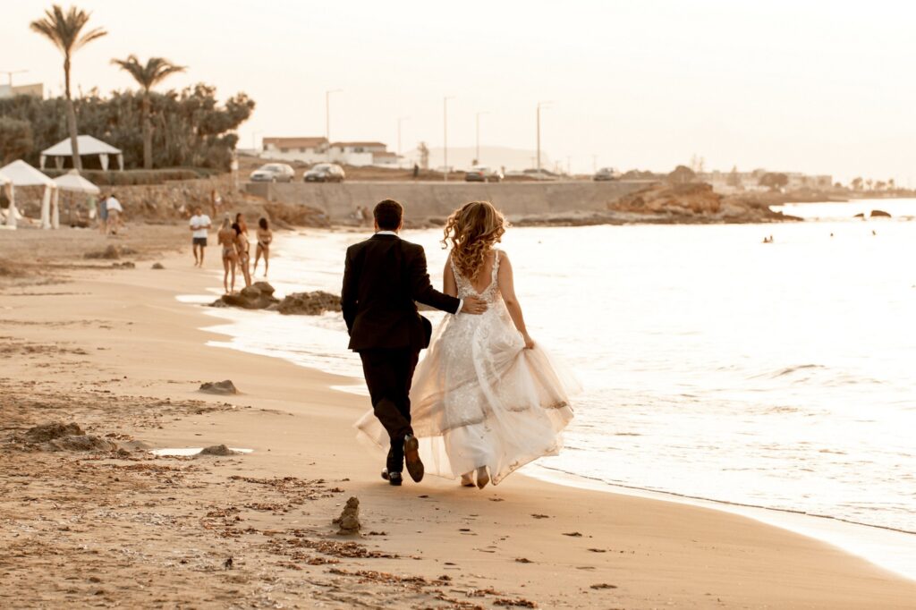 Theodore and Marie walking together on the beach | Esthesis Events