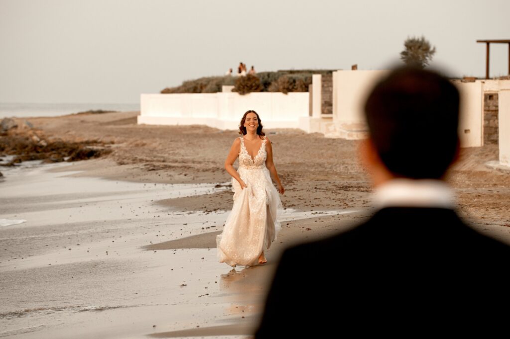 Marie approaches Theodore with a smile, while walking on the beach | Esthesis Events