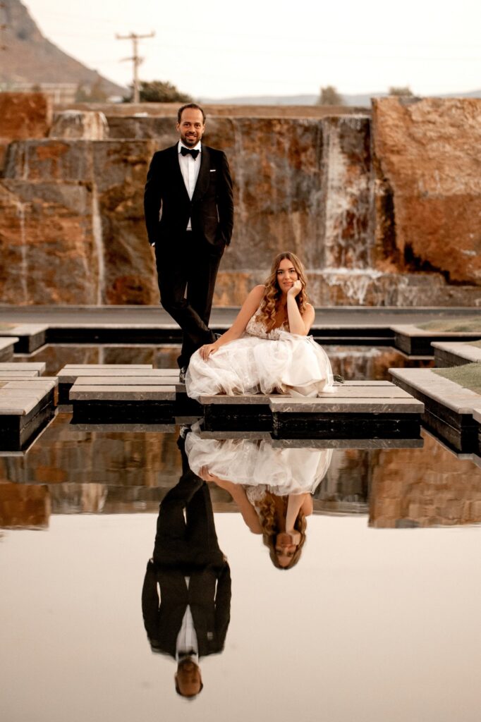 Theodore and Marie posing poolside at Kipos Aisthiseon | Esthesis Events