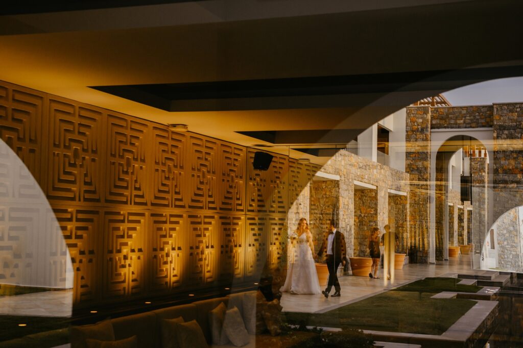 Marie and Theodore walk together while holding hands at Kipos Aisthiseon | Esthesis Events