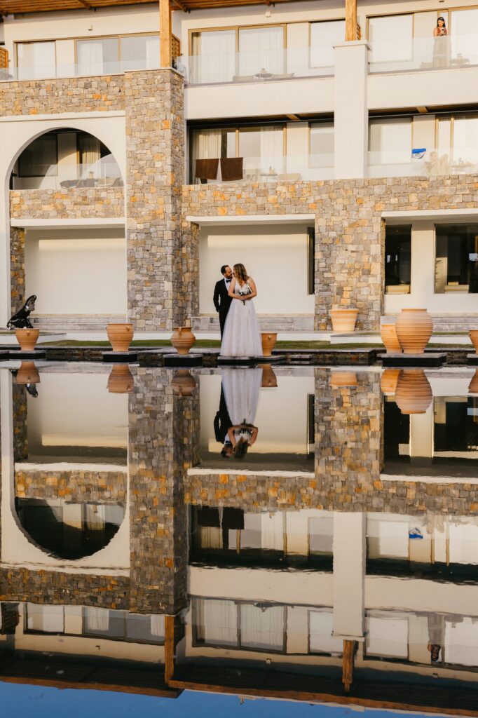 Theodore holding Marie poolside at Kipos Aisthiseon | Esthesis Events