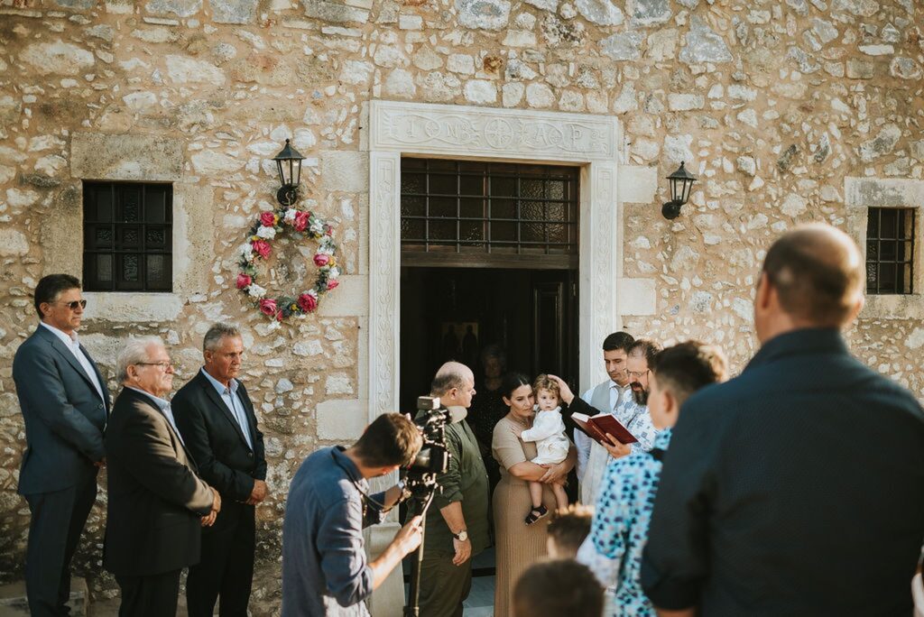 Yannis’ christening begins in the exterior courtyard of the monastery | Esthesis Events Yannis’ christening begins in the exterior courtyard of the monastery | Esthesis Events