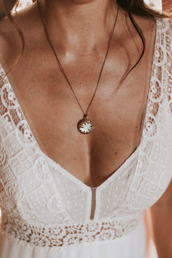 A detail shot of Jodie wearing a delicate necklace with her wedding gown. | Esthesis Events A detail shot of Jodie wearing a delicate necklace with her wedding gown. | Esthesis Events