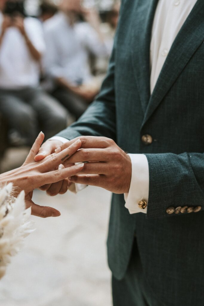 A close-up shot of Michael putting the wedding ring on his bride, Jodie. | Esthesis Events A close-up shot of Michael putting the wedding ring on his bride, Jodie. | Esthesis Events