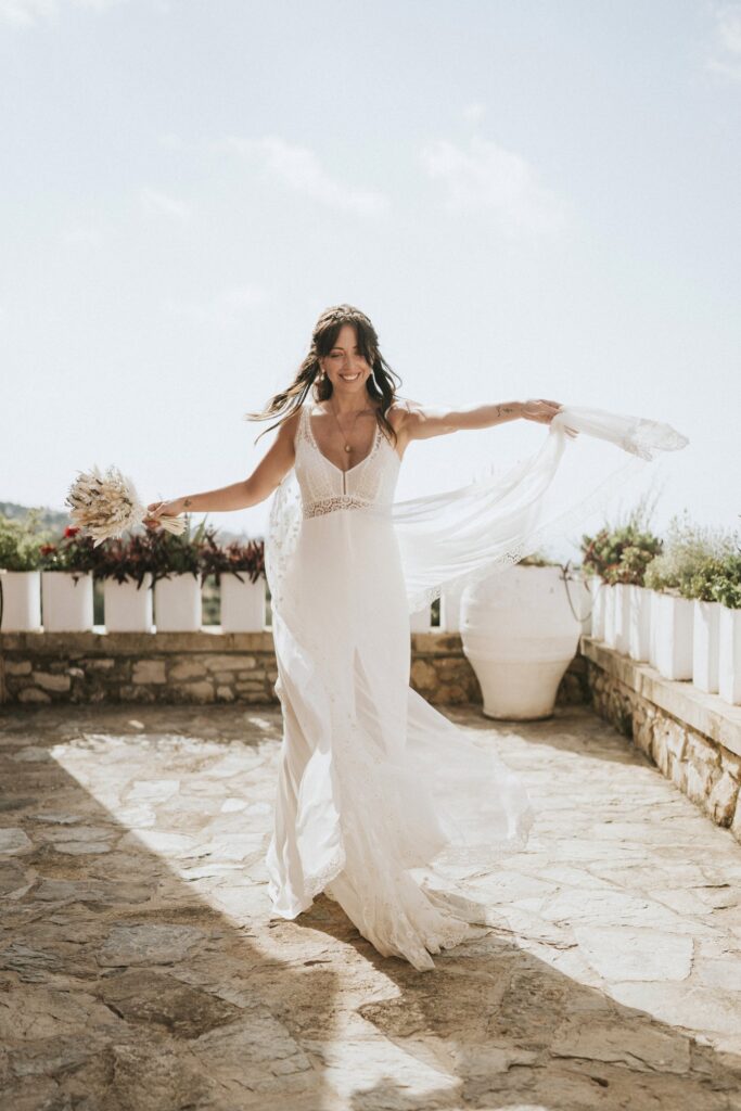 A beautiful portrait of the bride, Jodie, smiling warmly while showcasing her wedding gown and bouquet. | Esthesis Events A beautiful portrait of the bride, Jodie, smiling warmly while showcasing her wedding gown and bouquet. | Esthesis Events