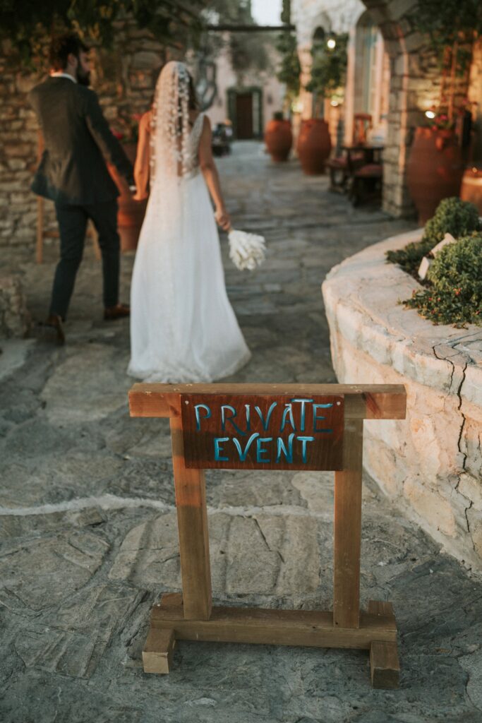 A rear view of the bride and groom holding hands and walking toward their outdoor wedding reception at Agreco Farm. | Esthesis Events A rear view of the bride and groom holding hands and walking toward their outdoor wedding reception at Agreco Farm. | Esthesis Events