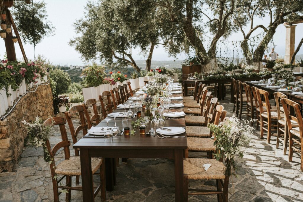 A close-up shot of the wedding reception dinner table decorations, floral arrangements, and seating at Agreco Farm. | Esthesis Events A close-up shot of the wedding reception dinner table decorations, floral arrangements, and seating at Agreco Farm. | Esthesis Events