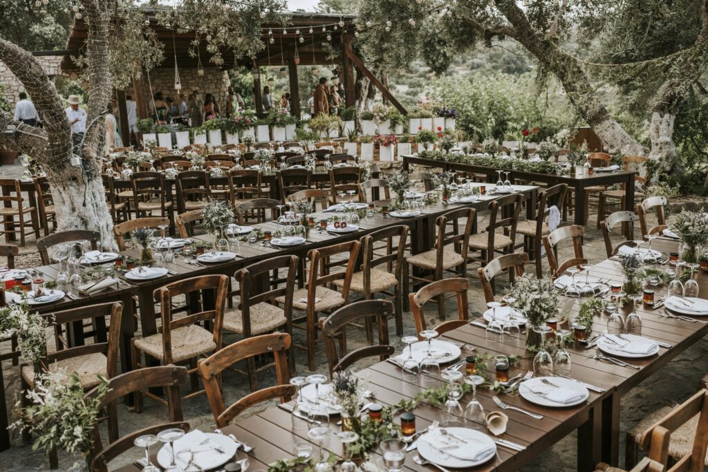 An outdoor wedding reception setup featuring multiple dinner tables and elegant decorations at Agreco Farm. | Esthesis Events An outdoor wedding reception setup featuring multiple dinner tables and elegant decorations at Agreco Farm. | Esthesis Events