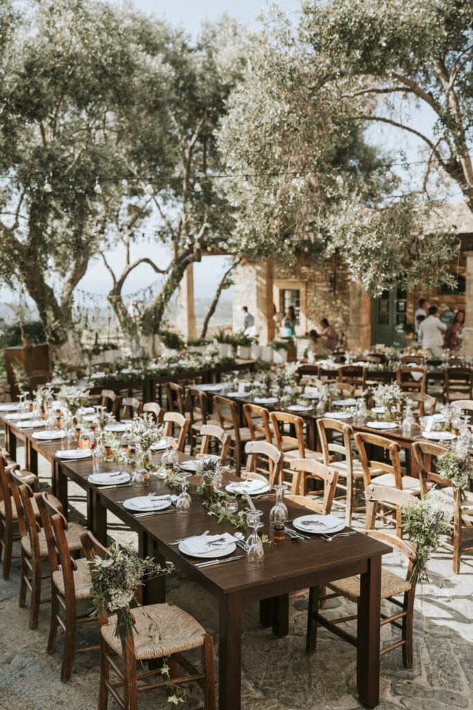 An outdoor wedding reception setup featuring multiple dinner tables and elegant decorations at Agreco Farm. | Esthesis Events An outdoor wedding reception setup featuring multiple dinner tables and elegant decorations at Agreco Farm. | Esthesis Events