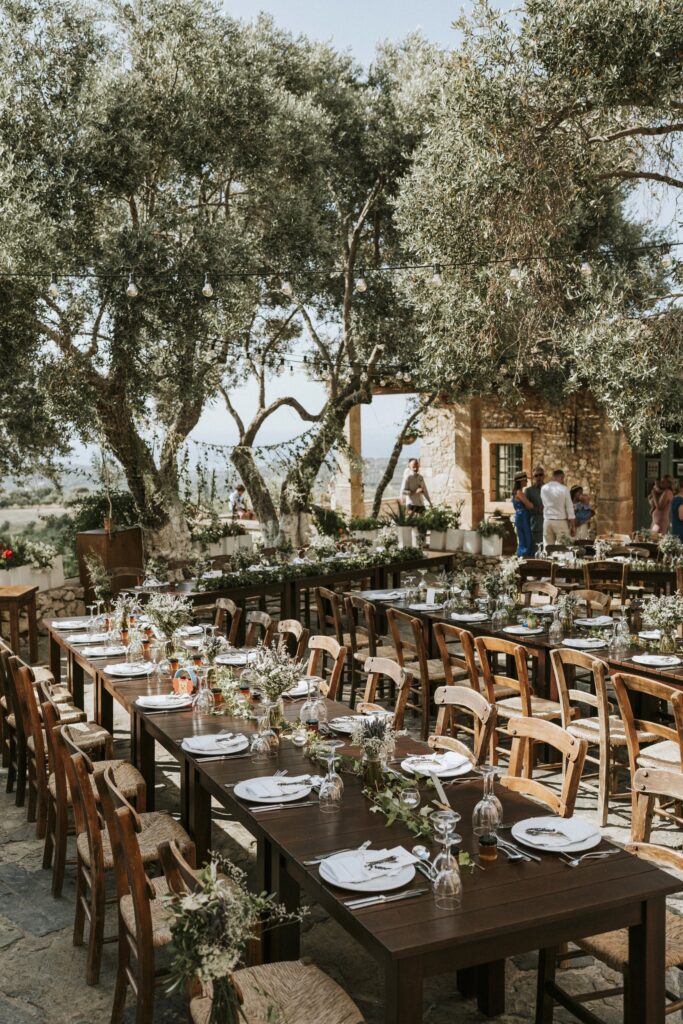 An outdoor wedding reception setup featuring multiple dinner tables and elegant decorations at Agreco Farm. | Esthesis Events An outdoor wedding reception setup featuring multiple dinner tables and elegant decorations at Agreco Farm. | Esthesis Events
