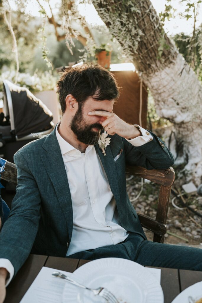 Michael playfully posing at the Agreco Farm wedding table. | Esthesis Events Michael playfully posing at the Agreco Farm wedding table. | Esthesis Events
