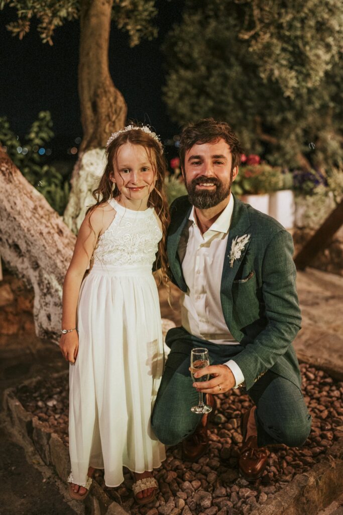 Michael posing with a little flower girl at his wedding. | Esthesis Events Michael posing with a little flower girl at his wedding. | Esthesis Events