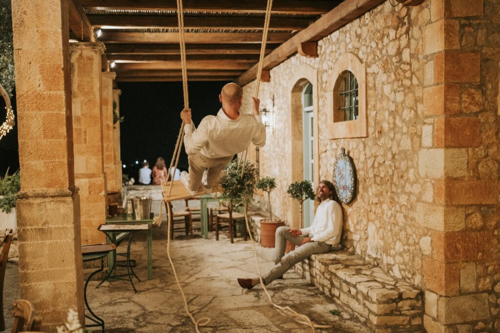 Wedding guest on a swing at the reception. | Esthesis Events Wedding guest on a swing at the reception. | Esthesis Events