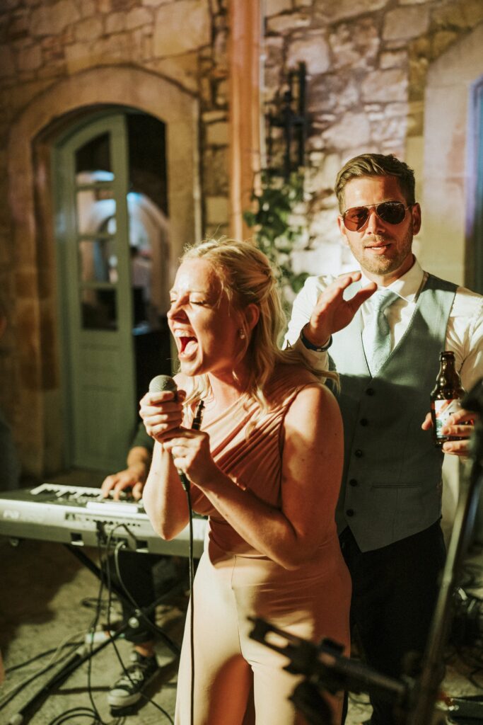 Wedding guest singing karaoke at the reception. | Esthesis Events Wedding guest singing karaoke at the reception. | Esthesis Events