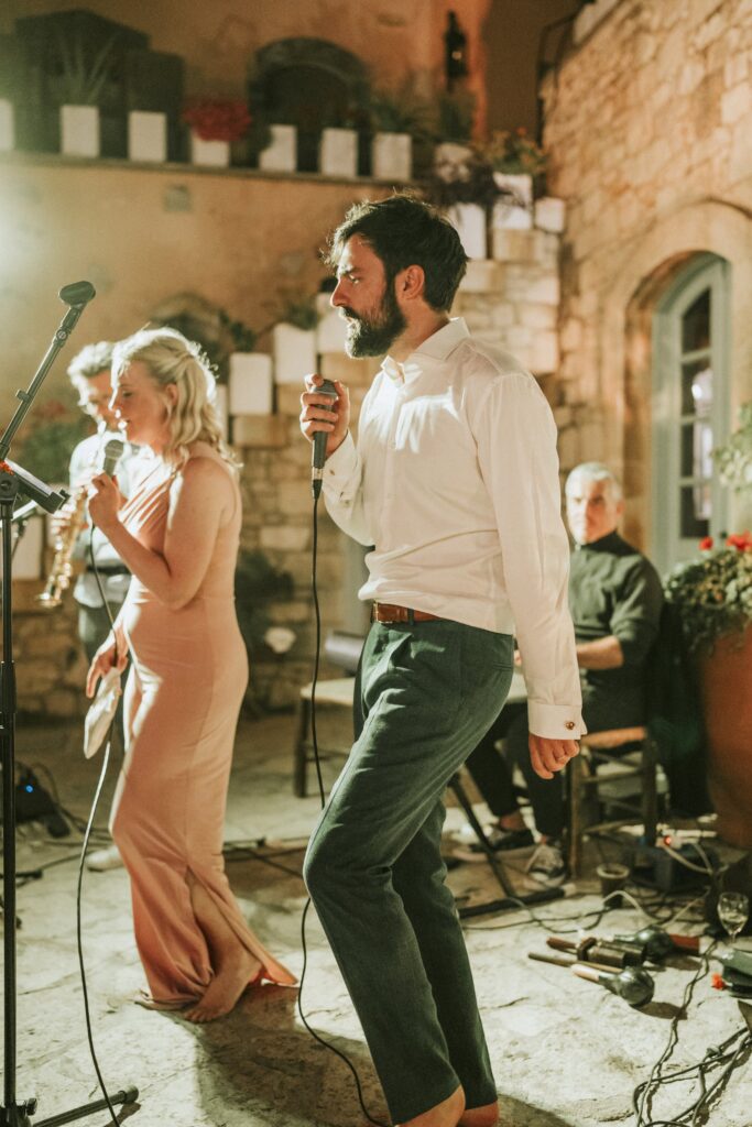 Michael singing karaoke with a guest at his wedding. | Esthesis Events Michael singing karaoke with a guest at his wedding. | Esthesis Events